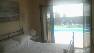 Master bedroom with french doors to pool terrace